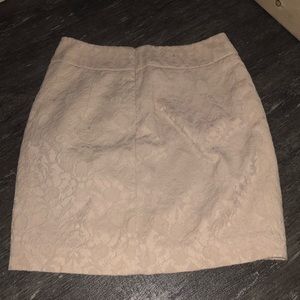 Cream colored, fitted mini skirt